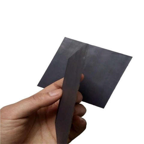 Five Pack Carbon Graphite Sheets 20x20x2mm for 3D Printing Crucibles and Tools held in hand, showcasing thickness and texture