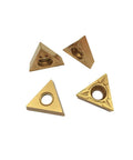 Four TCMT32.51 carbide turning inserts, triangular with center hole, yellow color
