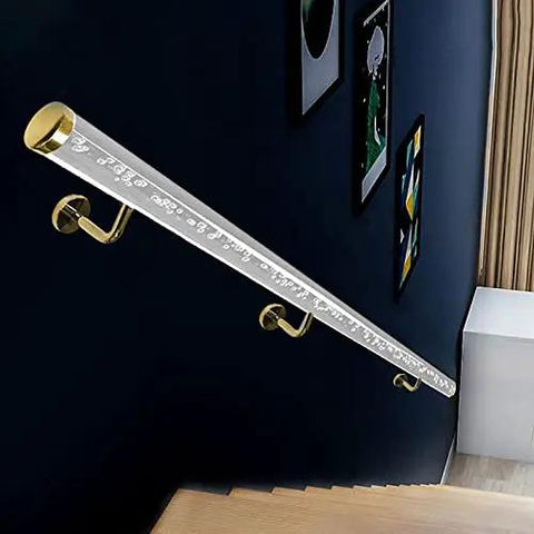 Top Shelf Indoor Acrylic Stair Handrail With Gold Wall Mount Brackets Built Tough Anti Slip Safety Grip Rail For Home Renovation Projects Custom Lengths Ready To Go installed on a dark wall.
