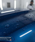 Front view of blue automotive clear coat finish on a car hood with water droplets; label visible