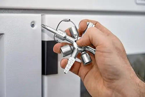 Hand holding TwinKey Multifunctional Spanner Kit with Magnetic Eight Arm Two By Four Way Spider Keys for control cabinets