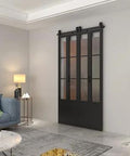 Frosted Glass Double Bi Fold Barn Doors With Black Steel Frame 48 Inch By 84 Inch Three Quarter Lites in living room setting