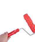 Killer DIY Doodle Dinosaur Wall Printing Roller with High Density Microfiber Cover and Sturdy Alloy Handle for Rad Home Decor Projects and Sick Wall Embossing Art held in hand.