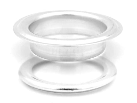 Close-up of a silver grommet from the 1.5 Inch Grommet Tool Kit for Curtains and Drapes for DIYers with Setter, Hole Punch Cutter.