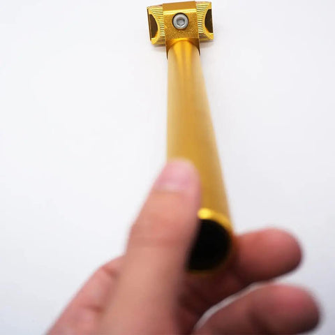 Adjustable 25.4x300mm Aluminum Alloy Seatpost For MTB Road Bike And BMX, gold finish being held by hand, showing length