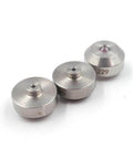 Front view: set of three stainless steel waterjet orifice inserts with central bores.