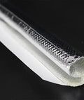 Close-up of Heavy-Duty Self-Wrap Aluminum Heat Shield Sleeve for hoses, wiring harnesses, and cables in automotive exhaust.