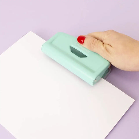 Person using 2 Hole Puncher With Waste Tray, 10 Sheet Capacity, Metal Puncher With Adjustable Guide, Non Slip Base, Mint Finish on paper