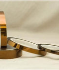 Premium Kapton Tape 1 Inch By 36 Yard Polyimide High Temp Tape With 1.5 Mil Silicone Adhesive rolls displayed on a surface.