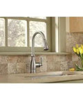 Traditional One Handle Kitchen Faucet In Spot Resist Stainless With Pull Down Sprayer Power Boost Quick Rinse Reflex Retractable Hose Dead Simple Install Slick Steel For Everyday Upgrades displayed in a kitchen setting with flowers.