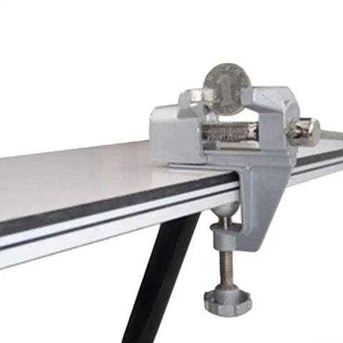Rock Solid Compact Swivel Vise For Crafters And DIYers That Secures Quickly To Tables Or Benches And Edges holding a coin