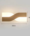 UPRENXIAO Modern Minimalist Nordic Led Wall Sconce Wavy Twisted Design Baked, 28cm x 10cm with soft light emission.