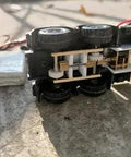 12V DC Mini Gear Motor N20 with D Shaft, fixed frame, plastic wheels shown in a DIY toy project setup for robotics.