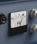 Close-up of a kV meter gauge on electrical equipment, showing needle at 9. Display in focus next to control knobs and connectors.