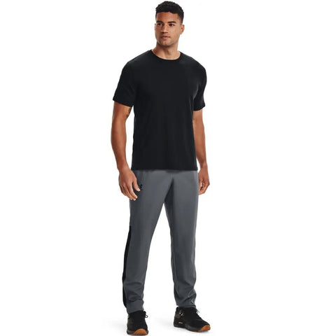 Model wearing Mens Woven Vital Workout Pants With Ripstop Fabric Regular Fit Joggers Windbreaker Style Lightweight Construction Pitch Gray Black XX Large