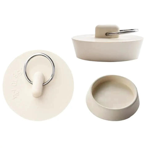 Close-up of a white rubber sink stopper with pull ring, universal fit for kitchen or bath, part of Six Size Rubber Sink Stoppers With Pull Ring Universal Fit Drain Plugs Fits Kitchen Bath Laundry Tub Leak Proof Anti Odor No Hassle Install Works Like A Champ For Every Home Owner Who Demands Top Notch Plumbing Fixes.