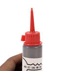 Close-up of a 60ml bottle of Graphite Garage Door And Lock Lubricant 60ml Oil Free Powder Formula For Sliding Doors And Hinges with red cap.