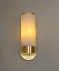 Single Natural Alabaster Rock Wall Sconce With Polished Brass Trim Features E14 Socket And Game Changer Soft Glow To Bring Killer Vibes To Bathrooms Bedrooms Halls As Sleek Wall Fixture, showcasing soft illumination.