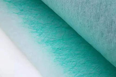 Close-up of Straight Up Solid Green Fiberglass Paint Arrestor Roll For Spray Booth Floor Filters showing layered material.