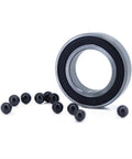 Smooth Hybrid Ceramic 63803 Bearing With Si3N4 Balls, 17x26x7mm beside ceramic balls on white background.