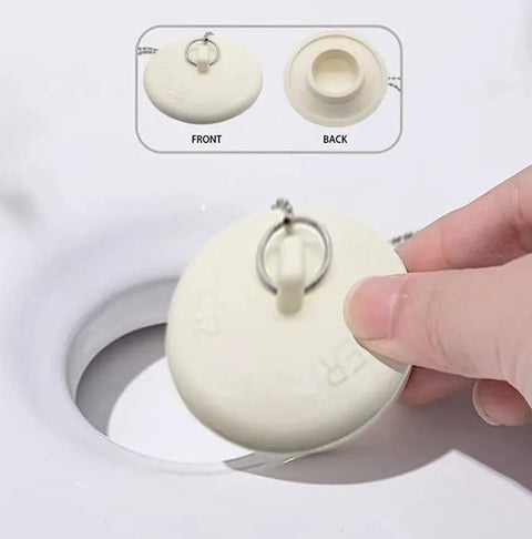 Top Shelf Rubber Tub Stopper With Pull Chain For Bathroom Sink And Shower Drain Cover Fits One Half To Two Inch Kitchen Laundry Plug being removed.