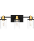 Three Light Black And Gold Bathroom Vanity Light Fixtures Over Mirror With Clear Glass Shade, frontal view.