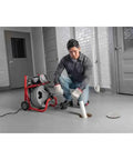 Heavy Duty 115 Volt Electric Conduit Bender Machine Featuring Autofeed And C45 Integral Wound Cable Designed To Bend Rigid Pipe Like Butter, in use by a contractor.