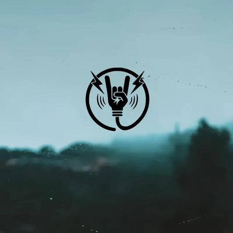 Premium Matte Rock Hand Electric Vehicle Charging Port Decal In Glossy Black Vinyl Featuring Iconic Lightning Bolt Graphic on a cool backdrop.