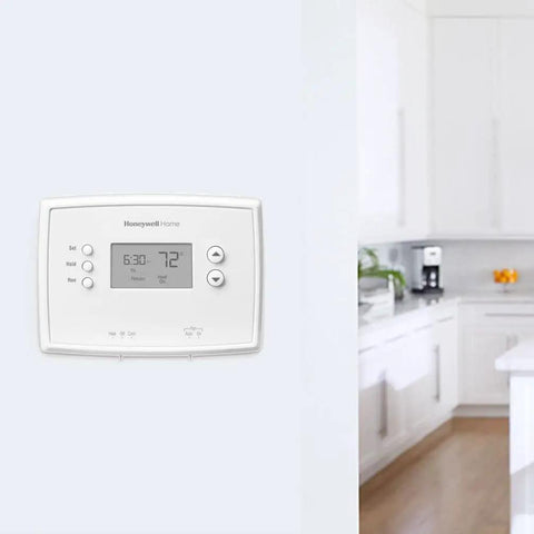 Programmable Thermostat With One Week Programming And Digital Display White in a modern kitchen setting on a wall