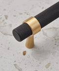 Knurled textured handle of solid brass cabinet pull in black with gold accents, part of a set of 2 with 5 inch hole centers.