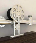 Close-up of installed stainless steel sliding barn door hardware kit for 10 foot double track set satin finish.