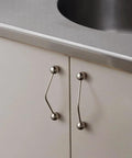 Kitchen cabinet installed with One Pack 5 Inch Titanium Silver Cabinet Handles Ball Tip Pulls With Polished Solid Brass Core And Premium Finish