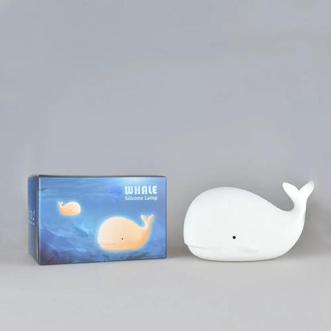 Under The Sea Nursery Night Light Whale Lamp for Baby and Toddler Room beside packaging box on gray background.