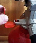 Hand removing safety tag from 5 lb fire extinguisher, showing red design for 100 Pack 5 Lb Fire Extinguisher Wall Brackets Universal Red Mount Holder Indoor Outdoor Heavy Duty Rack Bracket Solid Construction Made In Usa The Real Deal For Home Safety.