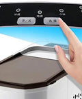 Top view of Compact Automatic Countertop Ice Maker controls with hand touching the panel for selection functionality.
