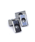 Two APKT-style milling inserts with central mounting holes, silver and black metal blocks.