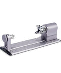 Next Level Rotary Module For Your Desktop Maker Machine Featuring Sweet 4 Axis Cnc Carving And Laser Engraving With Hella Precise Strain Wave Gearing And A Solid 3 Jaw Chuck Designed To Upgrade Any A350 Style 3D Printer Setup Today, gray rotary attachment with three jaw clamp.