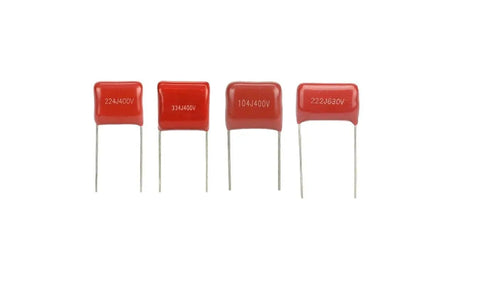Four red radial lead capacitors from Must-Have 180Pcs Metallized Film Capacitor Kit For DIY Electronics, PCB And Arduino Projects.