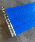Four By Two Hundred Fifty Foot Synthetic Roof Underlayment Pro Grade Heavy Slick Roll on the ground, showcasing blue synthetic material.