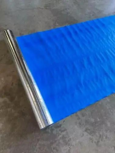 Four By Two Hundred Fifty Foot Synthetic Roof Underlayment Pro Grade Heavy Slick Roll on the ground, showcasing blue synthetic material.