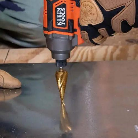 Step Drill Bit Set For Thin Metal Plastic Aluminum And Wood Seven Eighths To One And Three Eighths Inch in use by Klein Tools