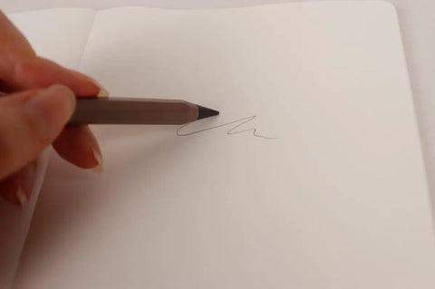 Ever Pencil Cap Set With A Sleek Metal Infinity Pencil writing smoothly on paper, showcasing ease of use and no sharpening needed.