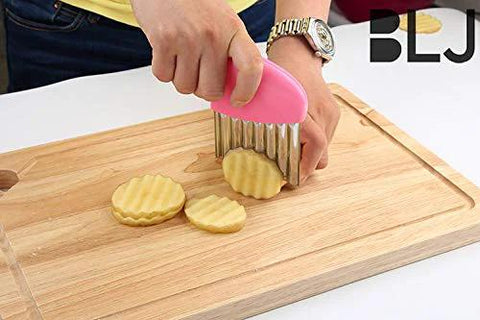 Crinkle-cutter knife with pink handle and stainless-steel blade slicing veggie rounds on a wooden cutting board (2-pack).