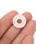 Full Ceramic Bearing ABEC-9 Precision ZrO2 Zirconia Deep Groove Ball Bearing 5x10x4 Millimeters held in hand for fishing reels.