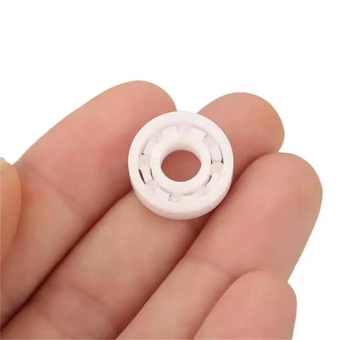 Full Ceramic Bearing ABEC-9 Precision ZrO2 Zirconia Deep Groove Ball Bearing 5x10x4 Millimeters held in hand for fishing reels.