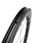 Close-up of Carbon Wheelset 700C Tubeless Road Wheels With Wave Rim 45mm 50mm Depth showcasing aerodynamic rim profile.