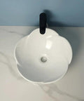 Bathroom Sink Ceramic Vessel Sink Bathroom Creative Petal Ceramic Counter Basin top view with faucet on white countertop.