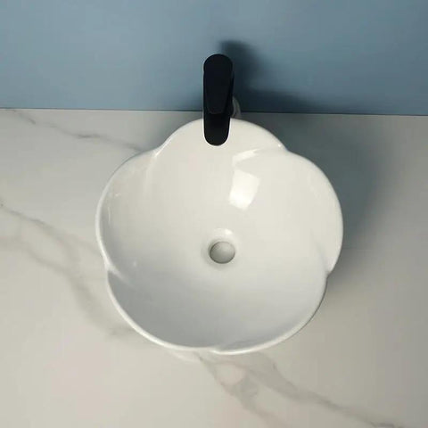 Bathroom Sink Ceramic Vessel Sink Bathroom Creative Petal Ceramic Counter Basin top view with faucet on white countertop.