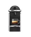 Front view of Pixie EN127S One Button Capsule Espresso Machine With a Legit 19 Bar Pump Quick Heat System Multi Function Brew Welcome Pack Included Ultra Compact Silver Coffee Maker For Home Office And Small Kitchens with a black coffee mug