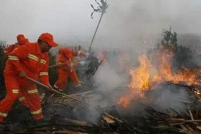 Heavy Duty Tough As Nails Red Fire Extinguisher With Long Handle Fire Mop Whip Pro Grade Emergency Safety Gear used in action by firefighters.